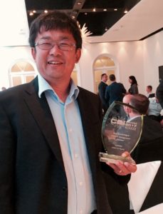 Conviva Team Member Proudly Holding The IABM Design & Innovation Award for Best Test Quality Control & Monitoring